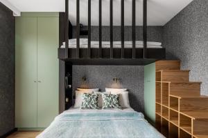 a bedroom with a bed with a loft bed at CITYSTAY Dluga Grobla Gdansk Apartment with Sauna in Gdańsk