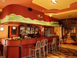 a bar in a restaurant with chairs around it at Hotel Primagor in Szydłowiec