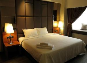 Postel nebo postele na pokoji v ubytování C'haya Hotel