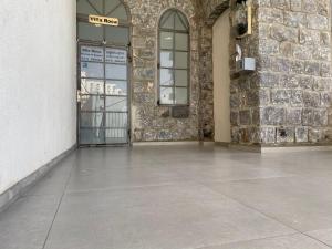 a building with a door and a stone wall at Puy Villa Roca Tiberias in Tiberias