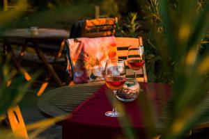 two glasses of wine sitting on a table at Пиргуля in Miladinowzi
