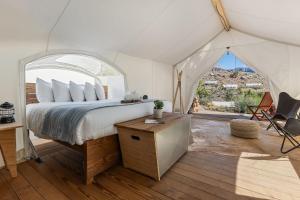a bedroom with a bed in a tent at Under Canvas Zion in Virgin