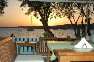 a table and chairs with a view of the water at Hotel Paros in Parikia