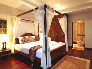 A bed or beds in a room at Kata Sea View Villas