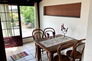 a dining room with a wooden table and chairs at CASA CUEVA DE LAS PALOMAS 1 in Las Manchas
