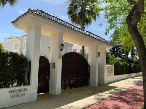 una casa blanca con una puerta y un árbol en CASA BAIANA - Dúplex en Costa Ballena, en Costa Ballena