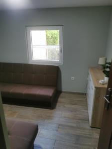 a living room with a couch and a window at Domek MajAmi in Turawa