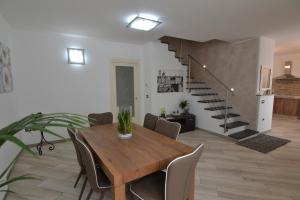 a dining room with a table and chairs and a staircase at B&B Canavaccio in Urbino