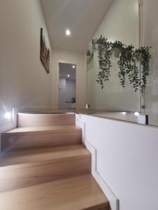 una habitación con una escalera con plantas en la pared en Apartamento Alto da Valeta, en Arcos de Valdevez