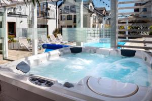 a jacuzzi tub on a patio next to a building at Orbisa Bis in Łeba