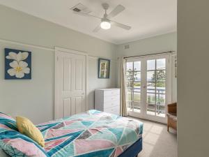a bedroom with a bed and a ceiling fan at Mon Reve 4A Tallean Road three bedroom property with air conditioning in Nelson Bay