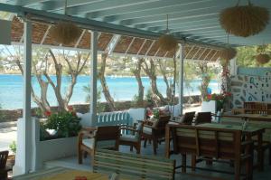 a restaurant with tables and chairs and a view of the ocean at Hotel Paros in Parikia