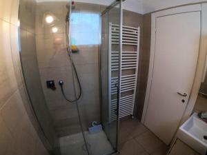 a shower in a bathroom with a glass shower stall at Orchidea Beach in Civitanova Marche +13 photos