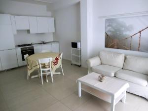 a living room with a couch and a table at Orchidea Beach in Civitanova Marche