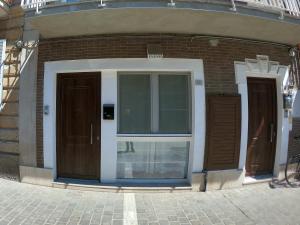 a building with two doors on the side of it at Orchidea Beach in Civitanova Marche