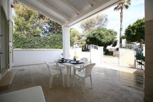 a white table and chairs on a patio at Le Bianche in Torre Suda