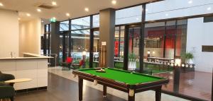 a pool table in the middle of a room at Essence Hotel Carlton in Melbourne