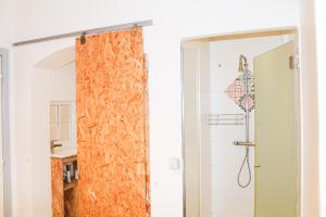 a room with a toilet and a door at Alface Hall Hostel & Bar in Lisbon