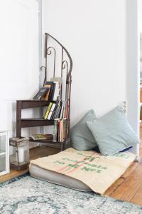 a bed sitting on top of a wooden floor next to a wall at Alface Hall Hostel & Bar in Lisbon