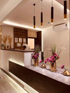 a kitchen with a counter with flowers on it at Quartz Executive in Abha