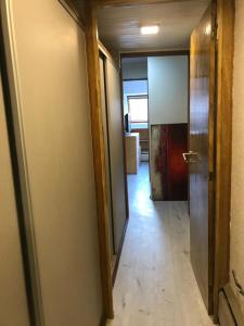 a hallway of a room with a door and a hallway at LAS LEÑAS - ATENAS - 5 Personas in Las Lenas +12 photos