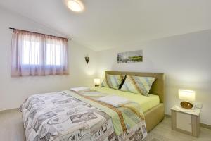 a bedroom with a bed and a window at Holiday Home Sandi in Pula