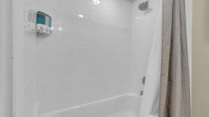 a white bathroom with a tub and a shower at Escape to Serenity in Colorado Springs