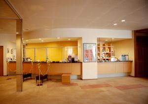 a kitchen with yellow cabinets and a table in a room at Grand Hotel Fujika in Nayoro