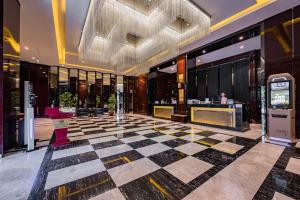 a lobby of a building with a checkered floor at Palace Hotels Beijing Yongfeng Nan(S) Subway Station in Beijing