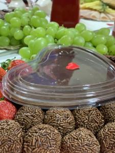 a display of chocolate dipped strawberries and green grapes at Suite Starfish in Guarujá +13 photos