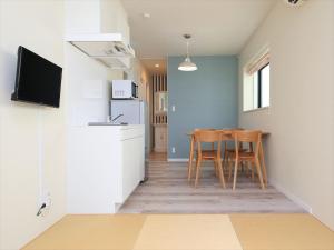 a kitchen with a table and chairs in a room at COTO Tokyo Shibuya 2 in Tokyo