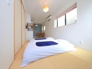 Ένα ή περισσότερα κρεβάτια σε δωμάτιο στο COTO Tokyo Shibuya 2