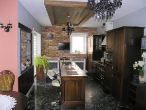 a kitchen with a island in the middle of a room at Siedlisko Inwałd in Inwałd