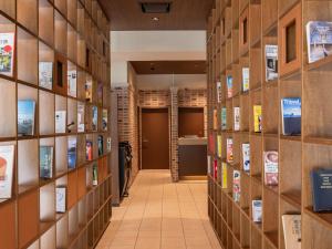einen Flur einer Bibliothek mit Bücherregalen in der Unterkunft ACCESS by LOISIR HOTEL Nagoya in Nagoya