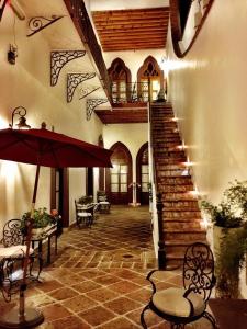 a living room filled with furniture and a staircase at El Serafin Hotel Boutique in Querétaro