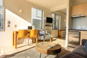 a kitchen and living room with a table and chairs at Villa Sapphire at Palm Beach in Palm Beach