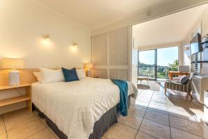 a bedroom with a bed and a large window at Villa Sapphire at Palm Beach in Palm Beach +15 photos