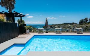 a swimming pool with a view of the ocean at Villa Sapphire at Palm Beach in Palm Beach