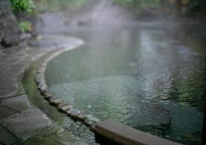 a body of water with steam coming out of it at Yufuin Onsen Hinoharu Ryokan in Yufu