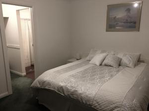 a bedroom with a bed and a picture on the wall at Golden Retreat in Golden Grove