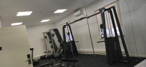 a gym with several tread machines in a room at Sulo Aksai Hotel in Aksay