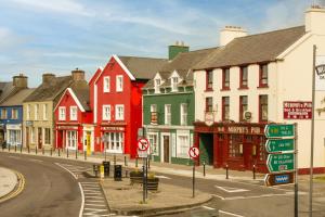 a city street with colorful houses and street signs at The Quayside B&B in Dingle