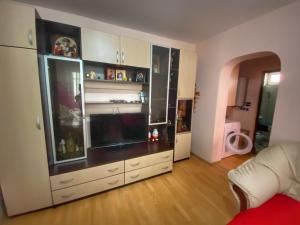 a living room with a large entertainment center at Apartament Sira in Sulina