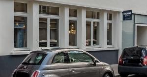 a silver car parked in front of a building at Ferdinand Hotel Tours in Tours