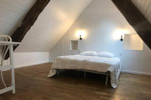 a bedroom with a bed in a attic at LITTLE BIRD in Dinan