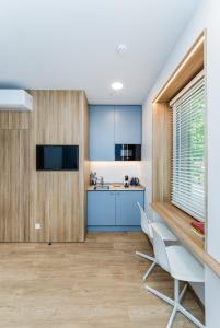 a kitchen with a table and chairs in a room at River city apartments No 5 by URBAN RENT in Kaunas