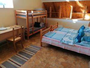 a room with two bunk beds and a table and a desk at 200m Sea ENGURE Kr Valdemāra 1 in Engure