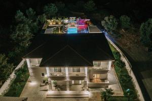 an aerial view of a house at night at M Mansion in Pefki