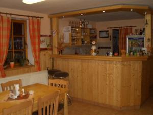 a restaurant with a bar and a table and chairs at Pension U Štěpánků in Trpišovice