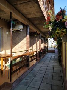 a balcony of a building with benches and flowers at La Kosta Zatoka in Zatoka